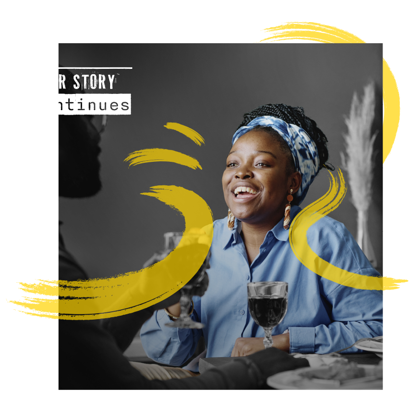 Here is an image of an African American woman in a joyous mood at her home, with a wine glass on the table. It highlights self-care and community care can be provided through at-home kits as part of the initiative.